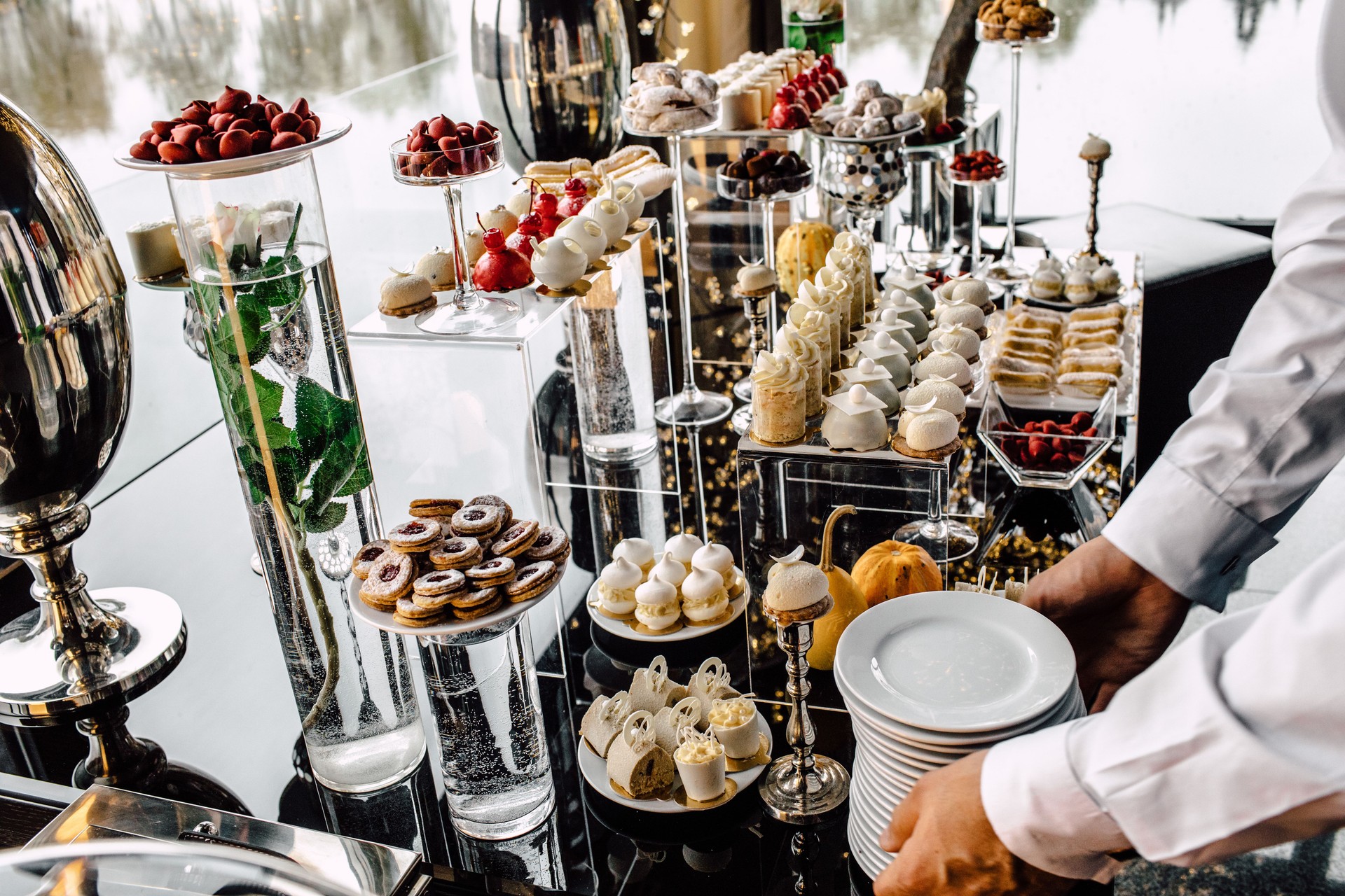 Restaurant waiter serving table with food
